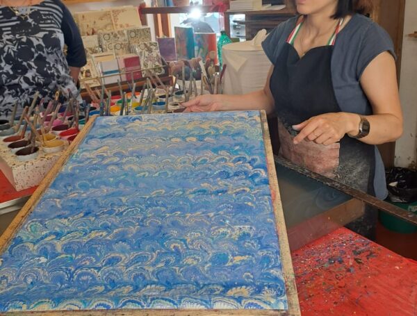 An artisan during a demonstration of paper marbling in Florence